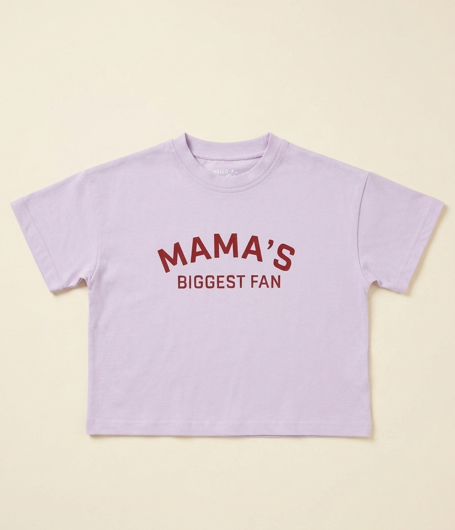 Lavender t-shirt with 'MAMA'S BIGGEST FAN' text on a beige background