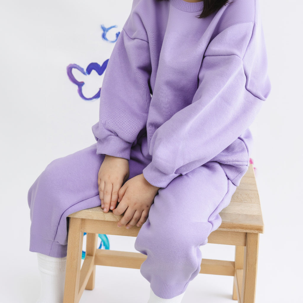 Hello Shams Original Set Soft Lilac — close-up detail of soft lavender jogger pants and ribbed cuffs on wooden stool