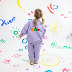 Hello Shams Original Set Soft Lilac — child wearing lavender cotton sweatshirt and jogger set with colorful HelloShams embroidery