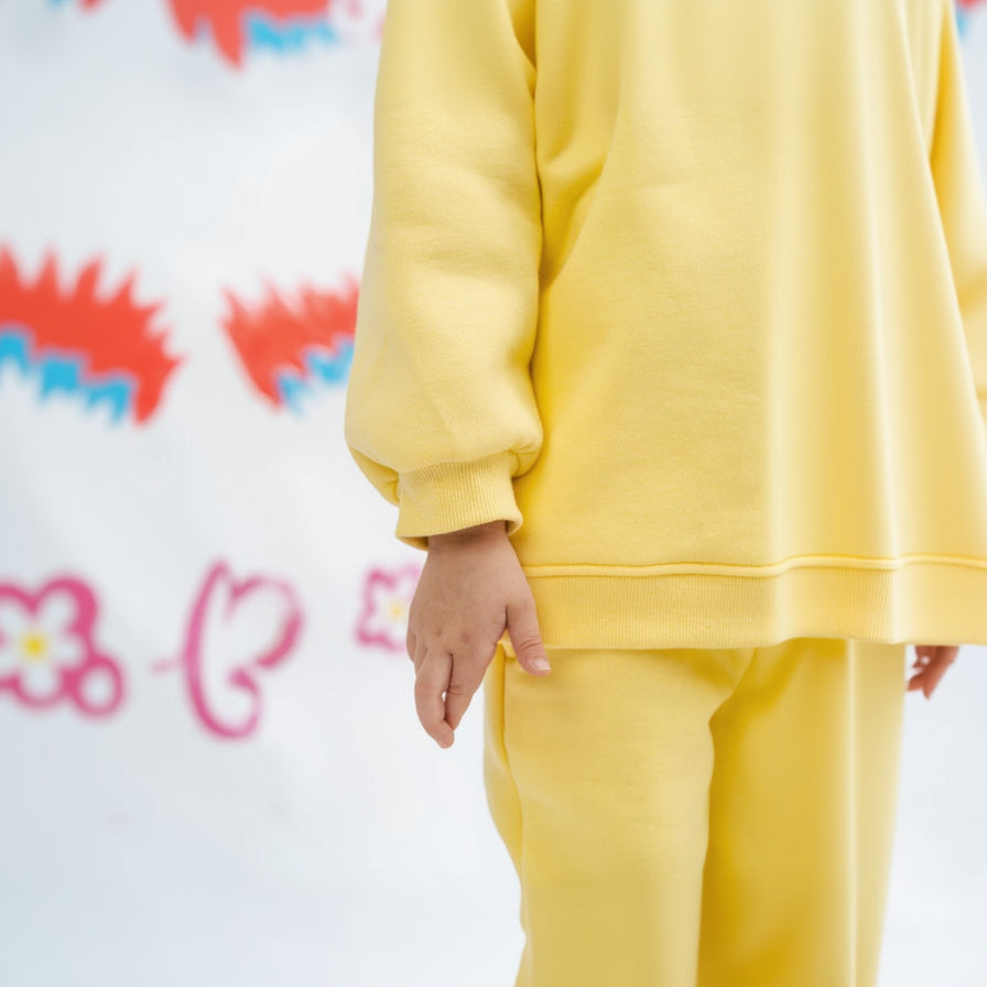 Kid wearing a yellow outfit with a blurred background, detailed shot